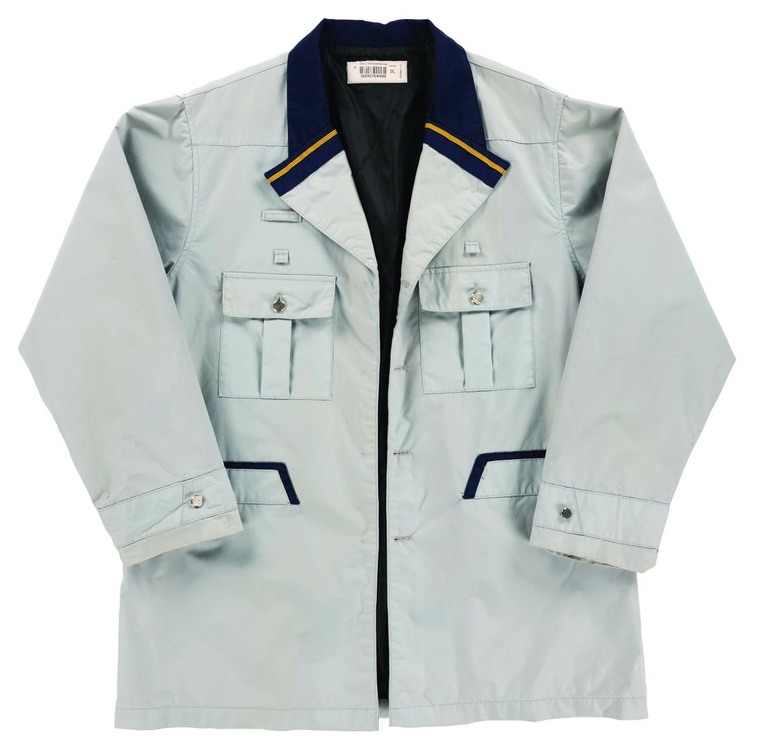 A Walt Disney World Monorail Pilot Jacket.: (Walt Disney World, 2010s) A costume jacket worn by Cast Members working as Monorail Pilots at the Walt Disney World Resort. Labeled a unisex size 2XL, the jacket is in very good condition with light