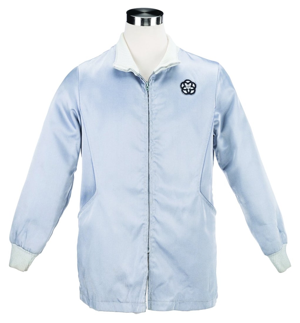 An EPCOT Center Silver Cast Member Jacket.: (EPCOT Center, 1982-94) A silver Cast Member jacket featuring the original EPCOT Center logo. Labeled a size M, the jacket is n good condition with pilling, scratches, scuffs, light stains, and wear f