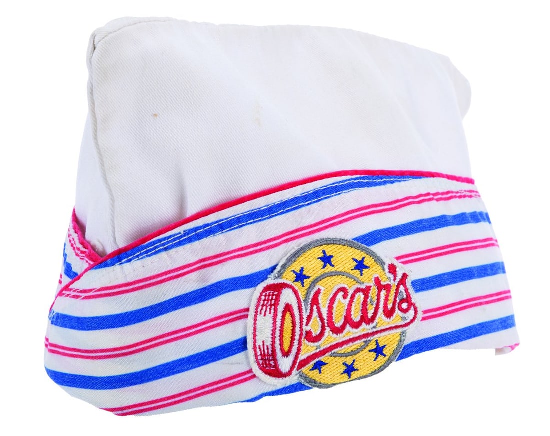 An Oscar's Super Service Cast Member Hat.: (Disney-MGM Studios, 1990s) A retro uniform hat worn by Cast Members working Oscar's Super Service, the merchandise shop located at the Disney-MGM Studios main entrance. Labeled a size L, the hat is i