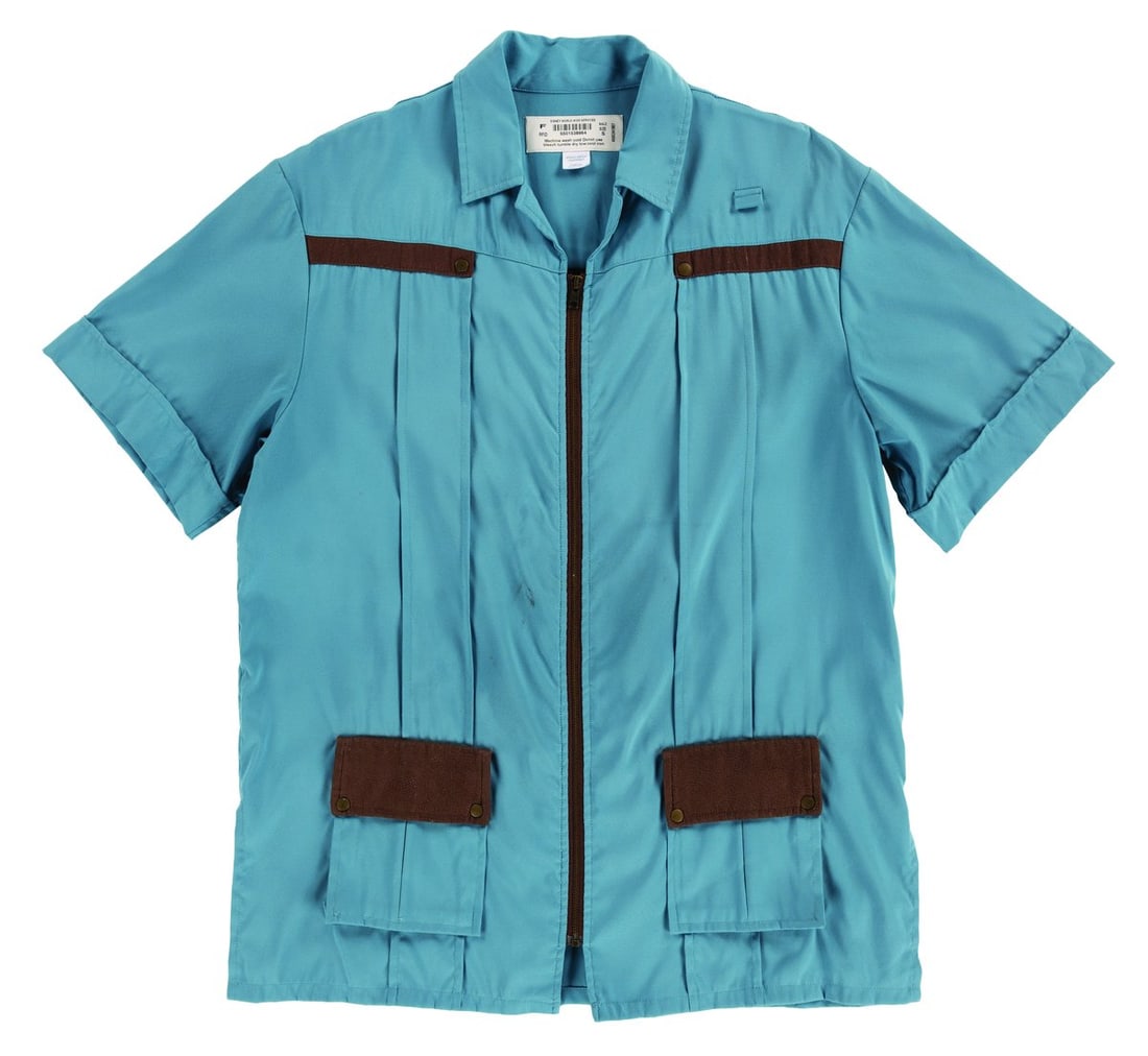 A DinoLand U.S.A. Cast Member Shirt.: (Disney's Animal Kingdom, 1998-2000s) A costume zip-up blue shirt with brown trim, worn by Cast Members working in DinoLand U.S.A. Labeled a male size S, the shirt is in good condition with discolorat