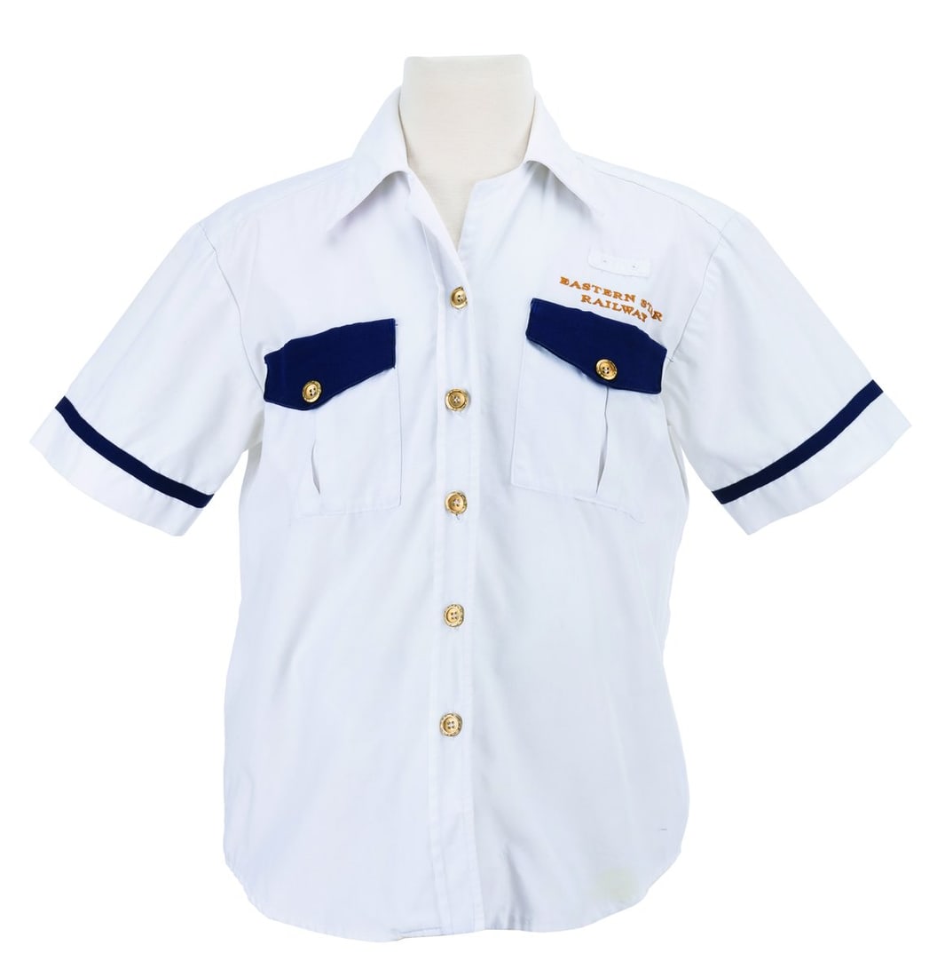An Eastern Star Railway Cast Member Shirt.: (Disney’s Animal Kingdom, 1998-2000s) A uniform shirt worn by Cast Members working the Eastern Star Railway, the fictitious company behind the Wildlife Express Train at Disney’s Animal Kingdom. La