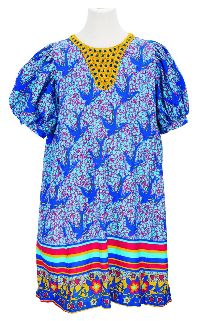 A Zuri’s Sweets Shop Cast Member Costume.: (Disney's Animal Kingdom, 2015) A colorful dress with a bird pattern, worn by Cast Members working at Zuri's Sweets Shop in the Africa section of Disney's Animal Kingdom. Labeled a size L, the Cast Me