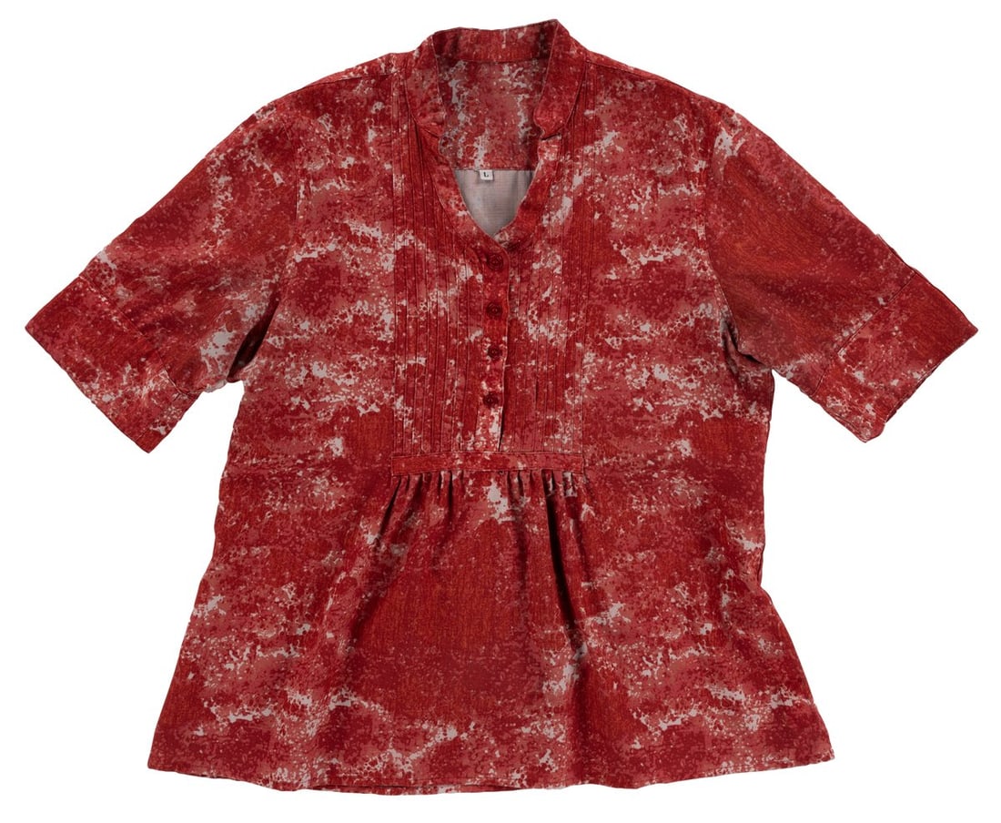 A Tren-D Cast Member Blouse.: (Walt Disney World, 2000s) A female uniform blouse worn by Cast Members working at the Tren-D shop in Disney Springs. Labeled a size L, the blouse is in good condition with typical wear from Resort us