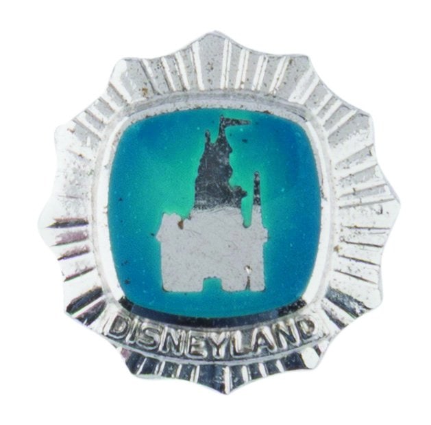 A Disneyland Cast Member 1-Year Service Pin.: (Disneyland, 1950s-70s) An early Disneyland sterling silver pin featuring Sleeping Beauty Castle, awarded to Cast Members upon completion of one year of service at the Park. Measuring 0.5" x 0.5", the