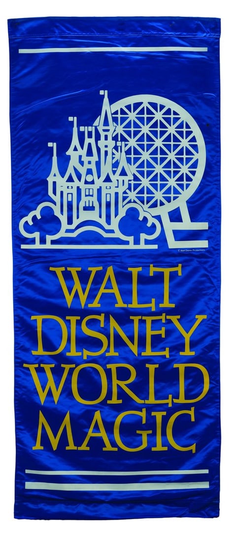 A Walt Disney World Magic Banner.: (Walt Disney World, 1982-88) A large blue satin banner promoting the magic of Walt Disney World. The double-sided banner showcases Cinderella Castle and Spaceship Earth, which represent the two parks