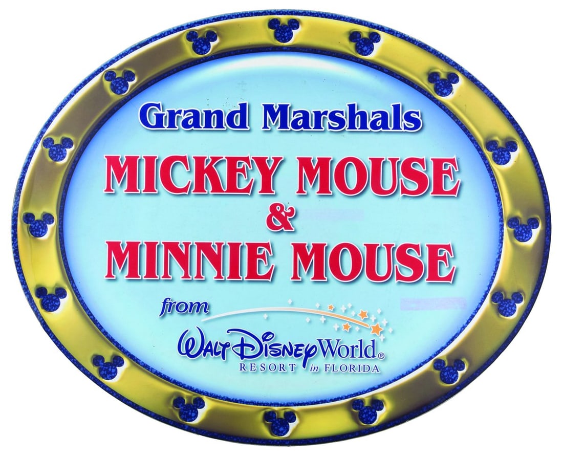 A Walt Disney World Magnetic Parade Sign.: (Disney, 2000s) A large magnetic sign announcing Mickey and Minnie Mouse as the Grand Marshals of a parade, likely displayed on a vehicle at a promotional appearance. Measuring 19.25” x 23.5&rdq