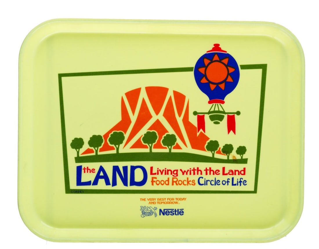 An Epcot Living with the Land Yellow Tray.: (Epcot, 1995-2004) A tray from The Land featuring the pavilion's attractions, Living with the Land, Food Rocks, and Circle of Life: An Environmental Fable, as well as the logo of its sponsor, Nestle.