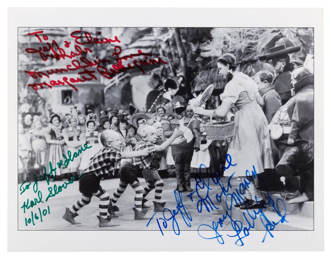 A Multi-Signed "The Wizard of Oz" Photo.: (MGM, 2001) A print of Dorothy in Munchkinland from "The Wizard of Oz," signed with dedications by three of the munchkin actors. Signatures include Karl Slover, Margaret Pellegrini, and Jerry Maren, o