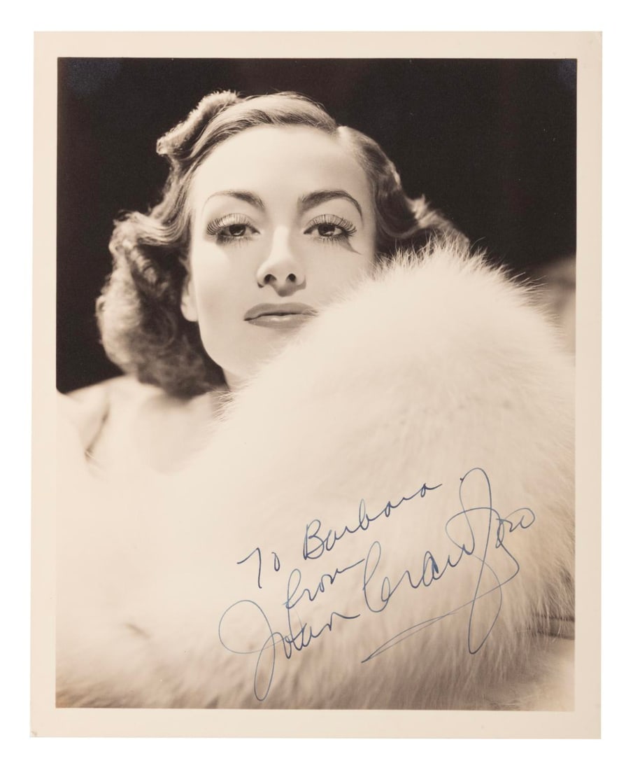 A Joan Crawford Signed Photo.: (Crawford, 1940s-50s) A photo of actress Joan Crawford, signed with dedication “To Barbara.” Measuring 8" x 10" the photo is in very good condition with light discoloration and edge wear.