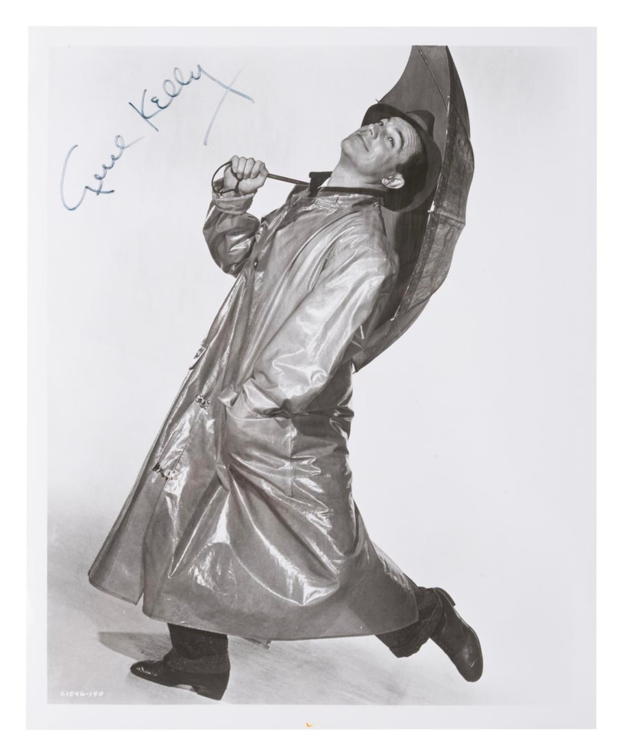 A Gene Kelly Signed "Singin' in the Rain" Photo.: (MGM, 1952) A publicity photo from "Singin' in the Rain," signed by star Gene Kelly. Measuring 8" x 10", the autographed photo is in good condition with scratches, wear, and a spot of discoloration
