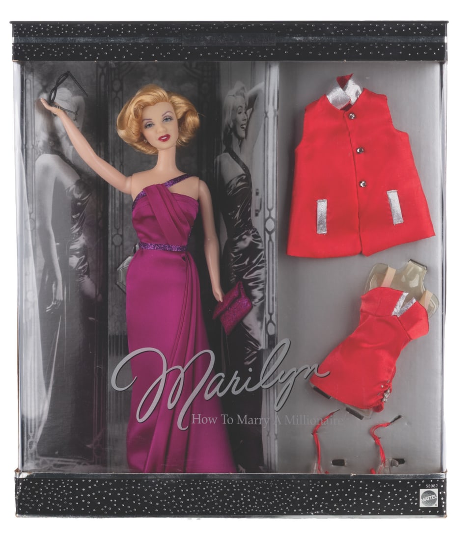 A "How To Marry A Millionaire" Marilyn Monroe Barbie.: (Mattel, 2001) A Collector's Edition doll of Marilyn Monroe as she appeared in "How to Marry a Millionaire." The doll wears the evening gown from the film, and also includes the iconic red swimsuit.