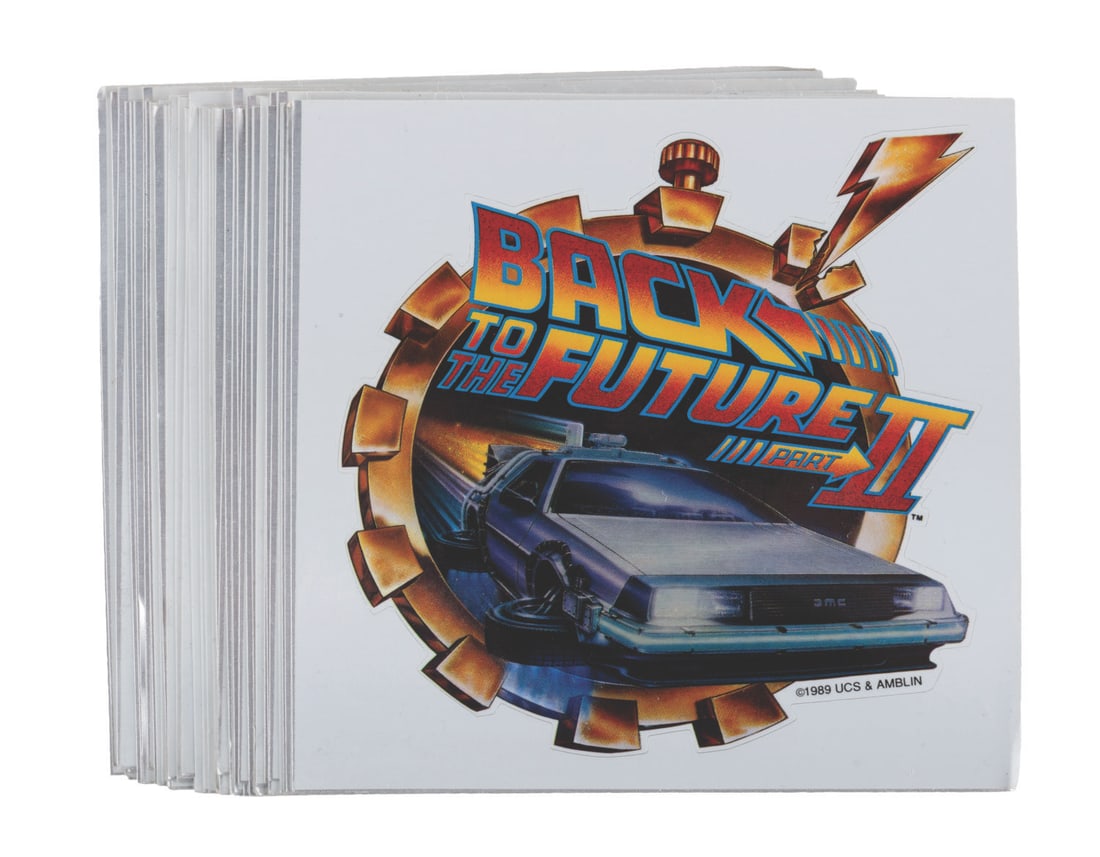 "Back to the Future Part II" Stickers.: (Universal, 1989) A collection of 35 stickers of the "Back to the Future Part II" logo. Measuring 5" x 5", the unused stickers are on their original cards and in very good condition with light