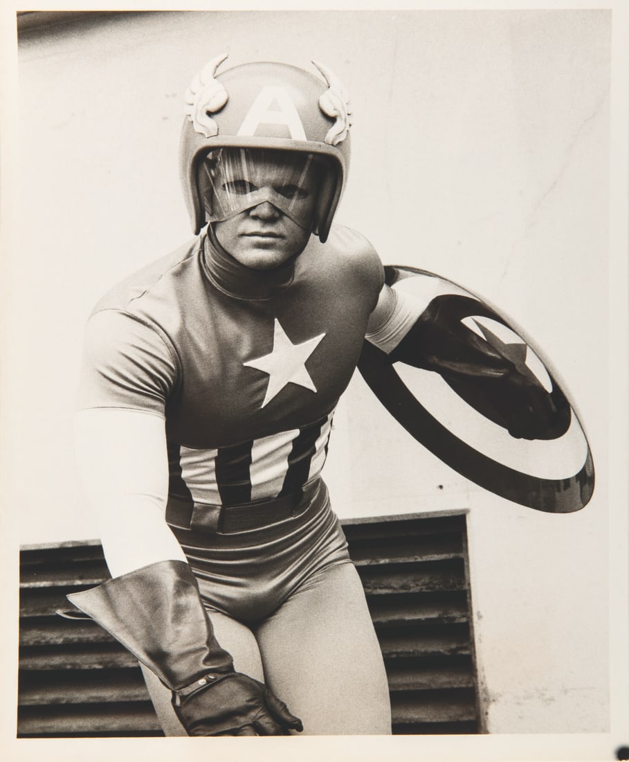 A "Captain America" 1979 Television Movie Photo.: (CBS, 1979) A promotional photo for the live-action TV movie “Captain America.” The photograph captures actor Reb Brown portraying the son of the original Captain America, carrying on his