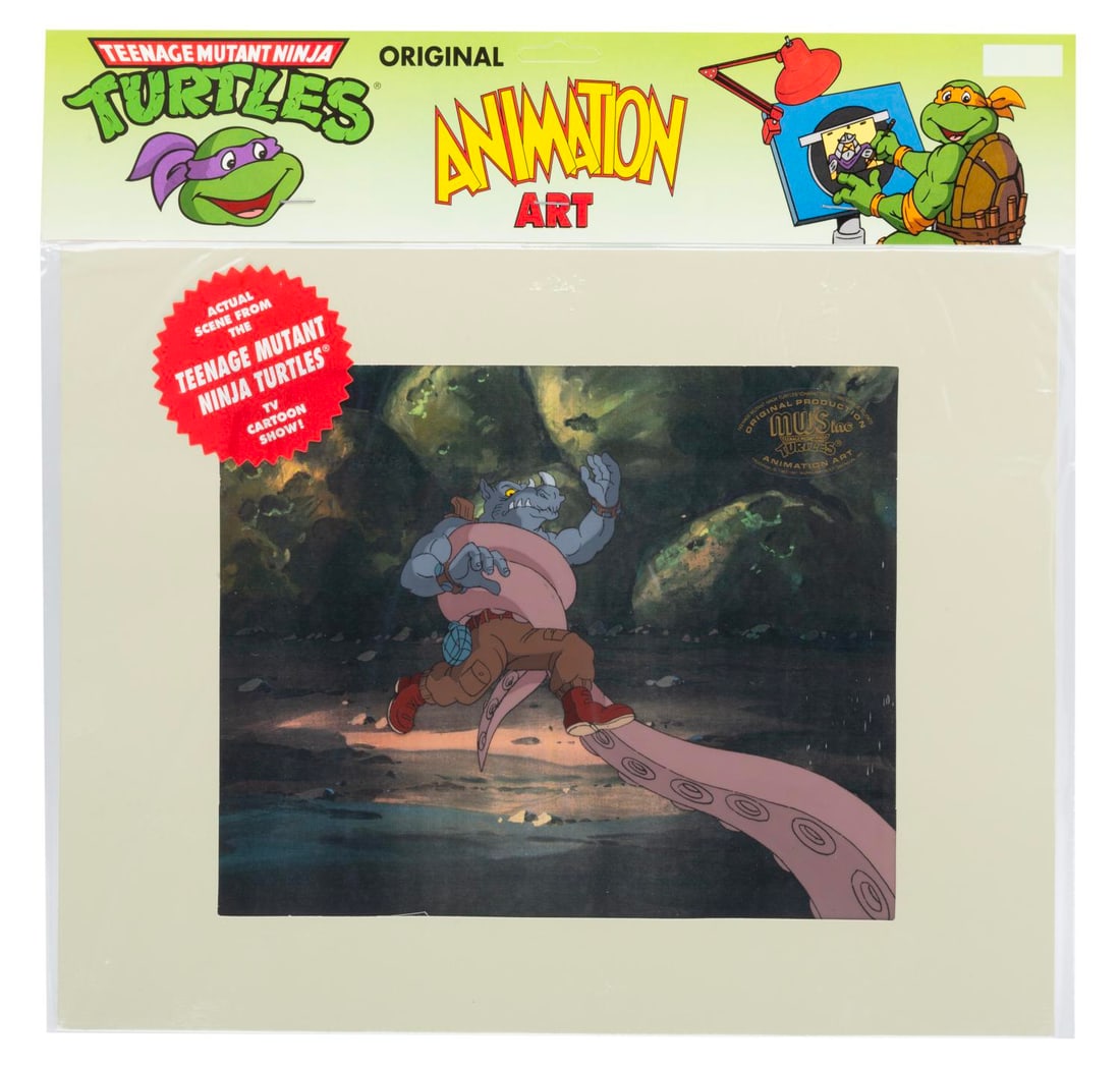 A "Teenage Mutant Ninja Turtles" Rocksteady Original Production Cel.: (Murakami-Wolf-Swenson, 1987-91) An original production cel of Rocksteady in the clutches of a tentacle from “Teenage Mutant Ninja Turtles” with a color copy background. Rocksteady and the