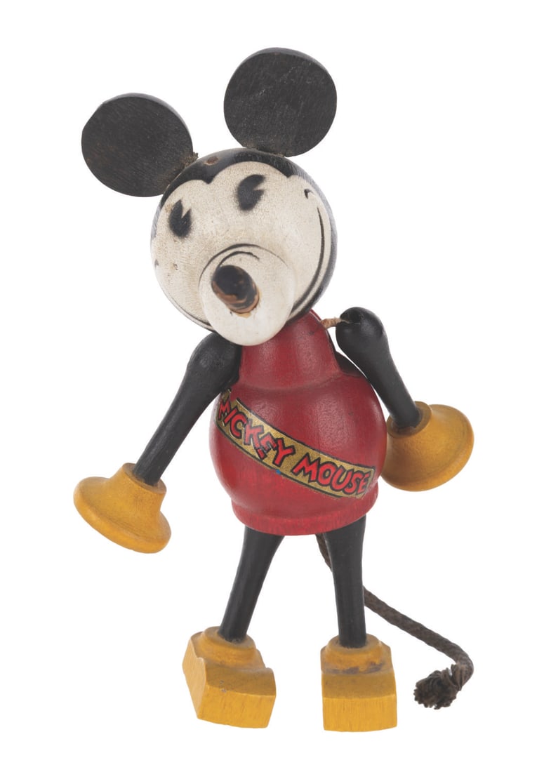 An Early Wooden Mickey Toy.: (Borgfeldt, 1930s) A wooden Mickey Mouse toy, manufactured by George Borgfeldt, one of the first licensed to make Disney Studio merchandise. Measuring 4.75" tall, the toy is in very good condition