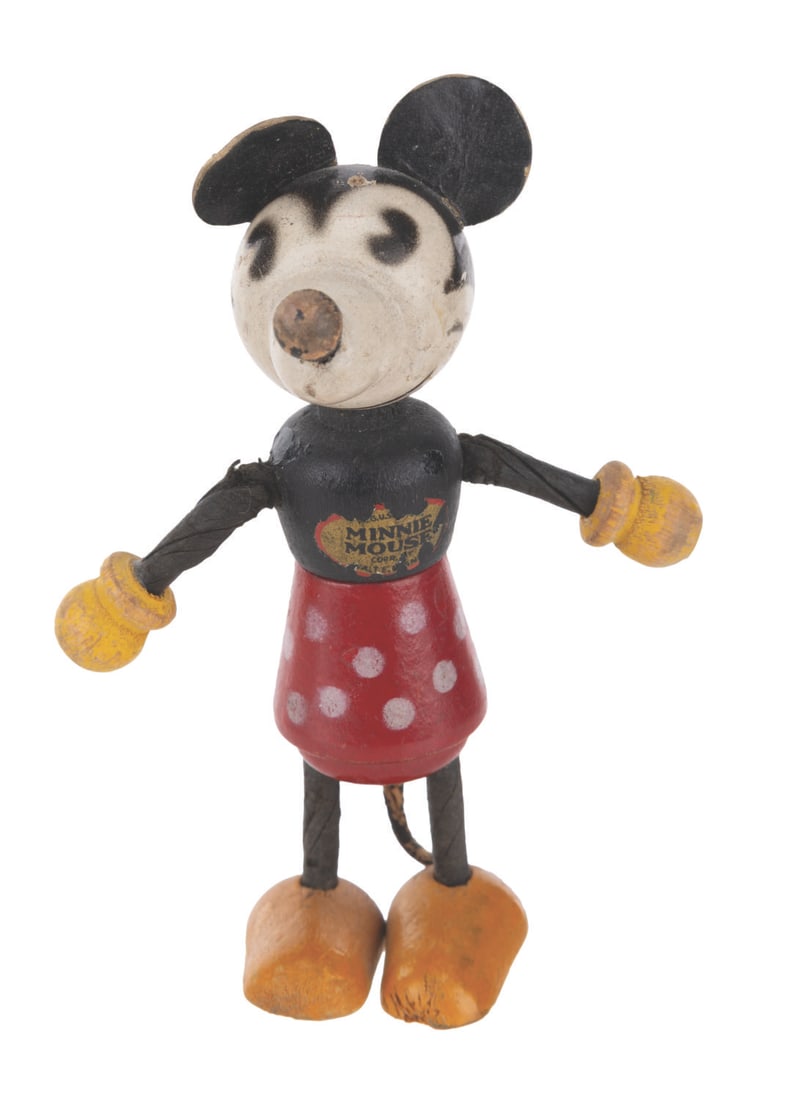 A Fun-E-Flex Wooden Minnie Mouse Doll.: (Disney, 1930s) A Fun-E-Flex wooden Minnie Mouse toy released in the early 1930s. Measuring 3.75" tall, the toy is in good condition with wear from use including paint loss to the nose, and missing he
