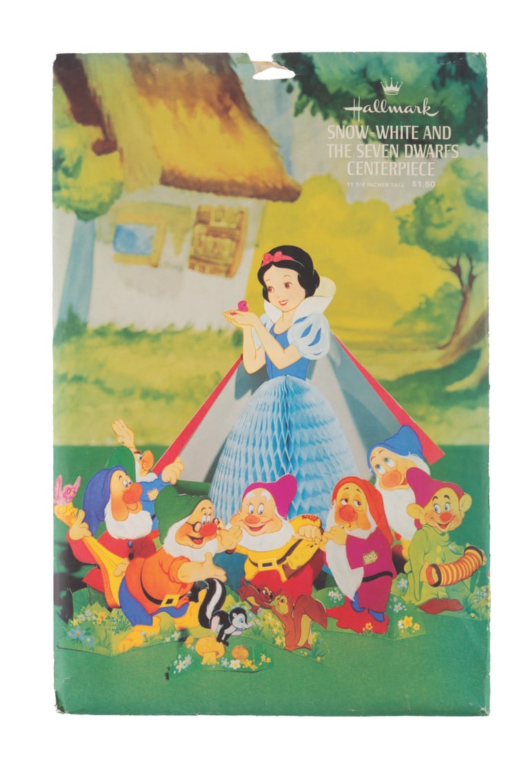 A “Snow White and the Seven Dwarfs?? Centerpiece Decoration.: (Hallmark, 1960s-70s) A sealed “Snow White and the Seven Dwarfs” centerpiece. Measuring 9.25” x 14”, the envelope is in good condition with wear from handling and age, with the