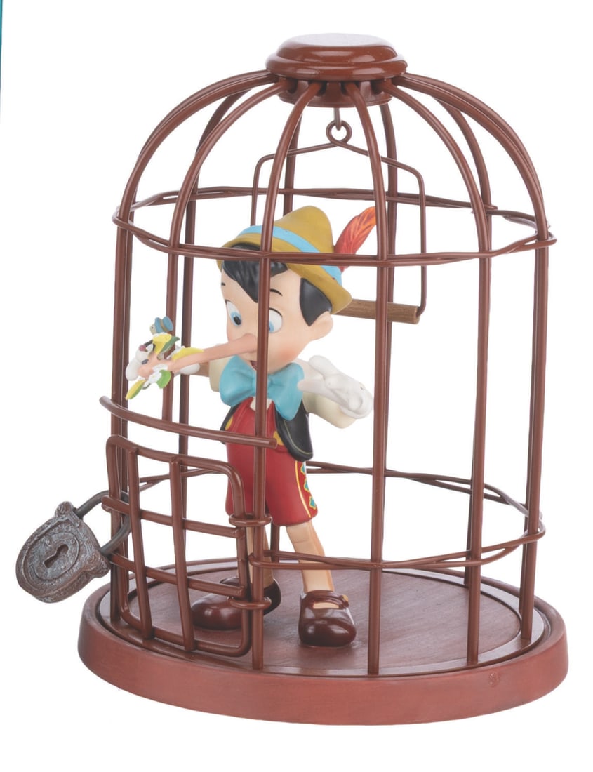A Repaired WDCC Pinocchio & Jiminy Cricket “I’ll Never Lie Again?? Figurine.: (WDCC, 2000) A repaired Walt Disney Classics Collection “Pinocchio” figurine of Pinocchio and Jiminy Cricket. Titled “I’ll Never Lie Again…”, the figurine was sculpted by Kent