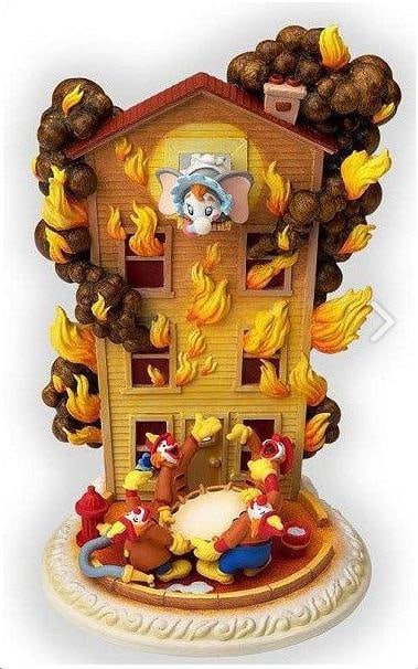 A "Dumbo" “We’ll Save Ya!?? Figure by Olszewski.: (Olszewski, 2002) A “We’ll Save Ya!” Story-Time figurine inspired by the scene in “Dumbo” where he reluctantly performs in the clown firemen act. Measuring 3.25” x 3.5”