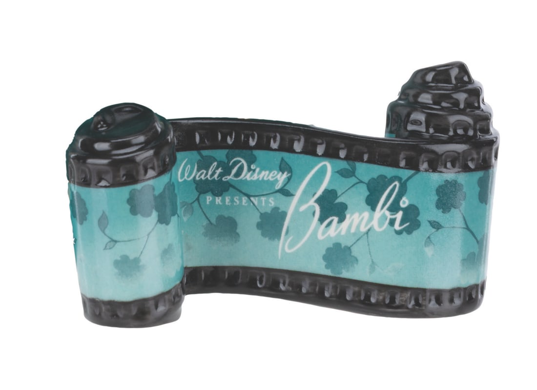 A WDCC "Bambi" Title Scroll.: (WDCC, 1991-2001) A "Bambi" opening title ceramic scroll from the Walt Disney Classics Collection. Measuring 2" x 3.25", the piece is in fine condition.