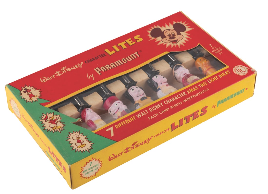 A Walt Disney Character Christmas Lites Set.: (Paramount, 1950s) A seven-piece Walt Disney Character Lites Set including Mickey and Minnie Mouse, Pluto, Jiminy Cricket, Pinocchio, one of the Three Pigs, and one of the Seven Dwarfs. Measuring