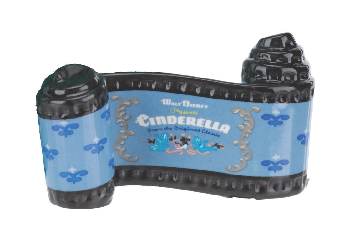 A WDCC "Cinderella" Title Scroll.: (WDCC, 1992-2001) A "Cinderella" opening title ceramic scroll from the Walt Disney Classics Collection. Measuring 1.25" x 3.25", the ceramic is in fine condition.
