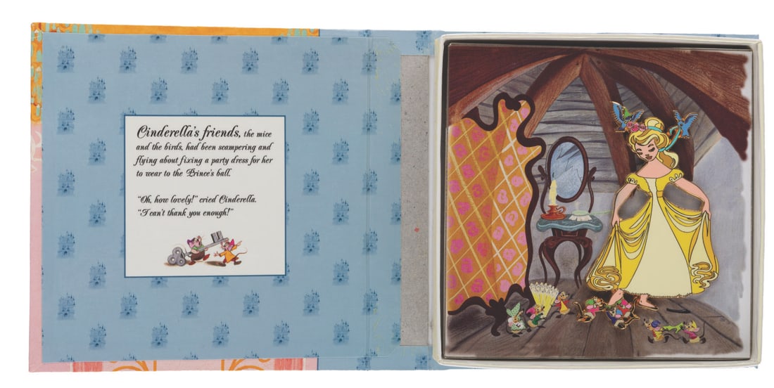 A "Cinderella: A Dress for the Ball" Storybook Collection Pin.: (Disney, 2002) A "Cinderella: A Dress for the Ball " jumbo pin in a storybook box. Measuring 3.75 " x 2.5 ", the pin is in fine condition.