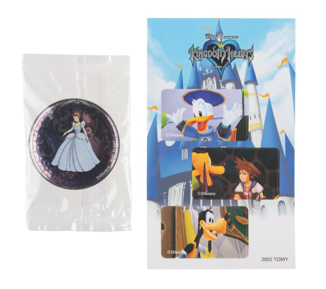 A Kingdom Hearts Cinderella Button.: (Tomy, 2002) A Cinderella Kingdom Hearts button. Measuring 1.5" in diameter, the button is in fine condition on the original card.