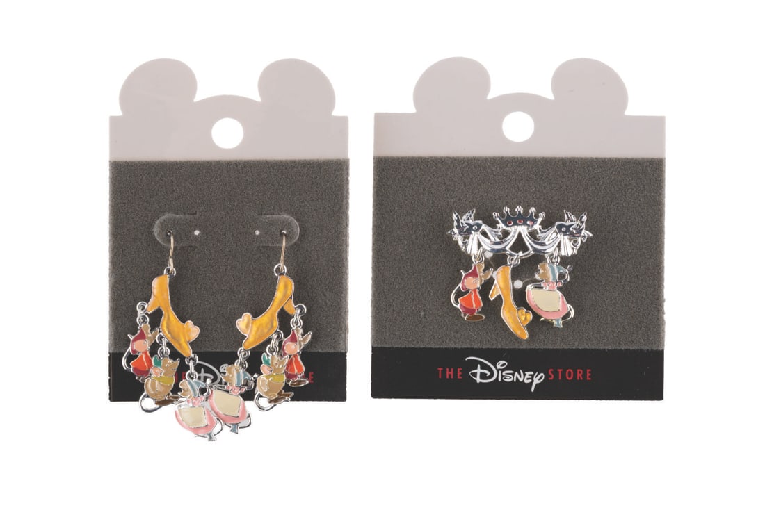 A "Cinderella" Brooch and Earring Set.: (Disney Store, 1990s) A "Cinderella" brooch pin and earring set featuring dangling charms of Jaq, Gus, a glass slipper, and Perla. The brooch and earrings are in very good condition on the original ca