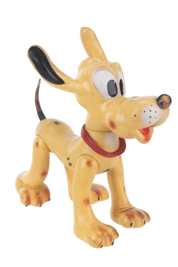 A Large Vinyl Toy Pluto.: (Disney, 1962) A soft vinyl Pluto toy jointed at the neck and legs. Measuring 4.75” x 12” x 11.5” tall, the toy is in condition with wear from play, and tacky to the touch from age.