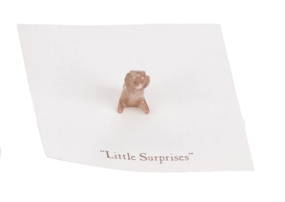 A Mini "Winnie the Pooh" Roo Figurine.: (Michel and Co., 1990s) A mini ceramic figurine of Roo, inspired by the original illustrations for the Winnie the Pooh books by E. H. Shepard. The figure is attached to a card with a quote that