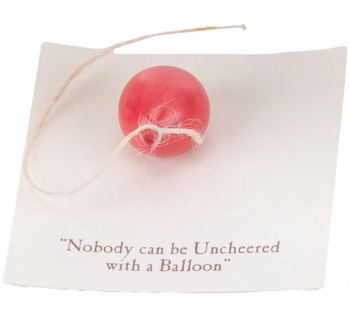 A Mini "Winnie the Pooh" Balloon Figurine.: (Michel and Co., 1990s) A mini "Winnie the Pooh" ceramic figurine of a red balloon inspired by the original illustrations for the books by E. H. Shepard. The figure is attached to a card with a quote 