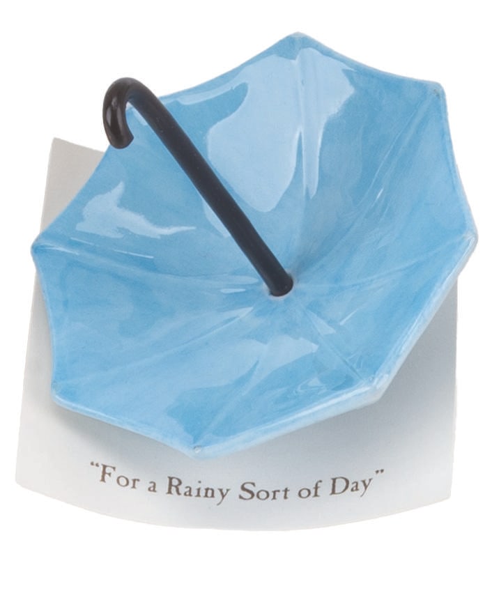 A Mini "Winnie the Pooh" Umbrella Figurine.: (Michel and Co., 1990s) A mini "Winnie the Pooh" ceramic figurine of an umbrella inspired by the original illustrations for the books by E. H. Shepard. The figurine is attached to a card with a quote 