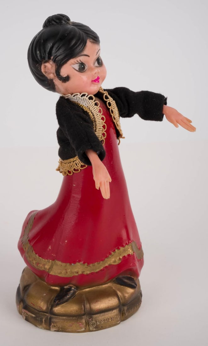A World’s Fair Small World Spanish Dancer Souvenir.: (Disney, 1964) A hand-painted Spanish dancer plastic figurine from it’s a small world’s original run at the 1964-65 World’s Fair in New York. Measuring 4” x 3.25” and 7.75” tal