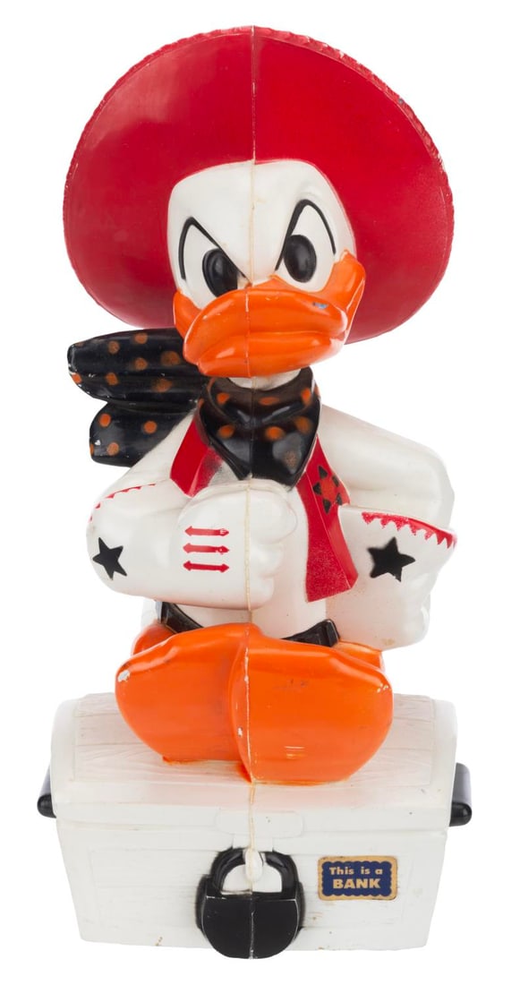 A Cowboy Donald Duck Bank.: (Knickerbocker, 1960s-70s) A figural bank of Donald Duck dressed as a cowboy, manufactured by Knickerbocker. Measuring 4” x 4” x 9”, the plastic bank is in good condition with light