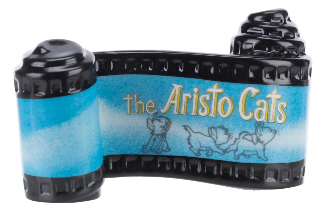 A WDCC "The Aristocats" Title Scroll.: (WDCC, 2000-2012) A "The Aristocats” opening title ceramic scroll from the Walt Disney Classics Collection. Measuring 2" x 3.25", the item is in fine condition.