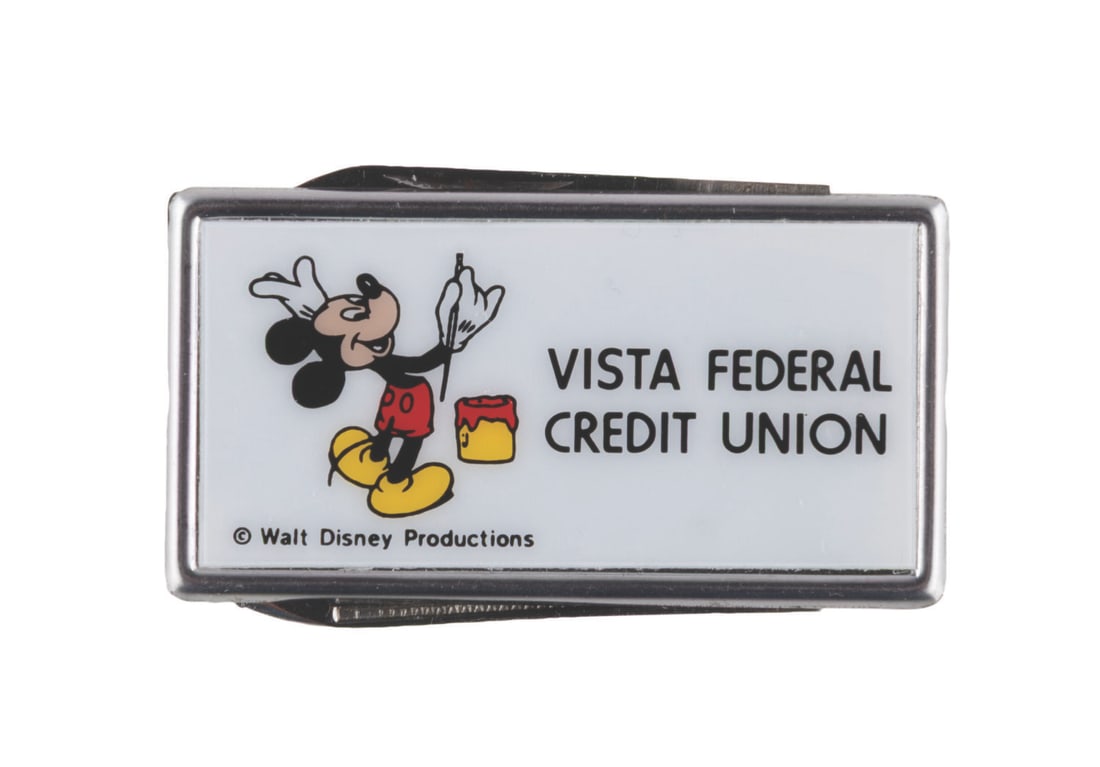 A Vista Federal Credit Union Money Clip.: (Disney, 1970s-80s) A Mickey Mouse money clip with a small file and knife blade, from the Walt Disney Company's Vista Federal Credit Union. Measuring 1.25" x 2", the clip is in very good to fine