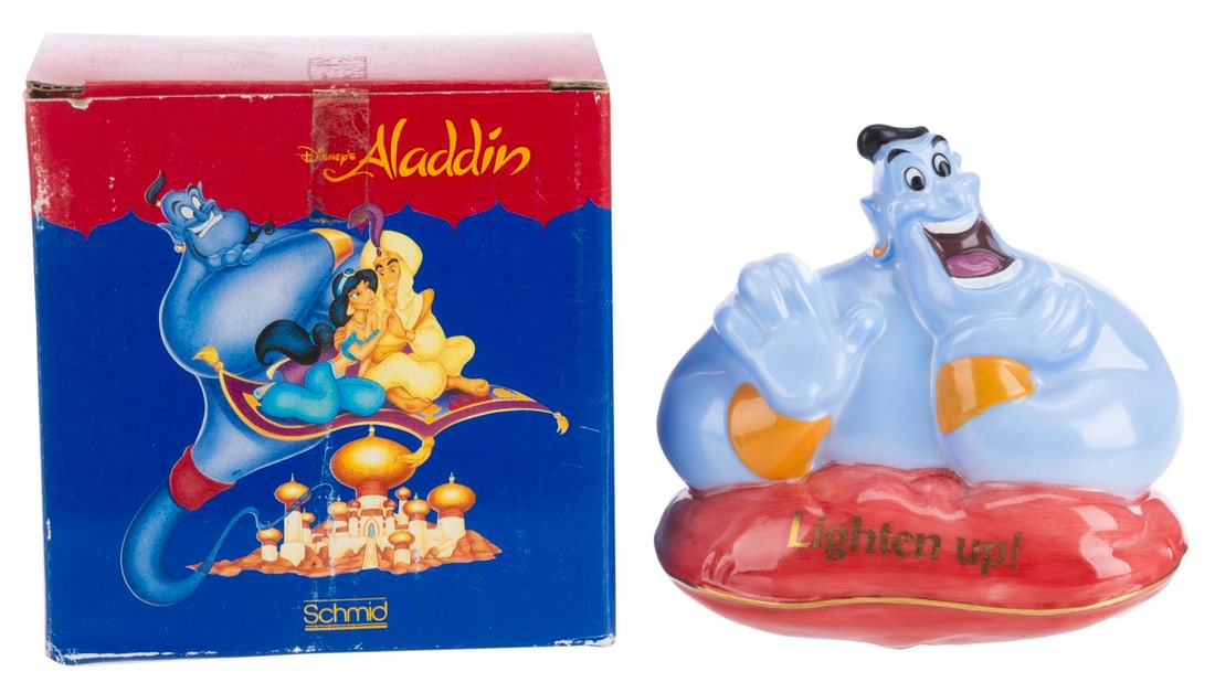 An "Aladdin" Genie Nightlight.: (Schmid, 1993) A hand-painted plug-in nightlight of the Genie from “Aladdin,” with “Lighten up!” on the front. Measuring 4” x 2” x 3.75” with its original box, the