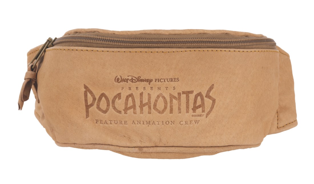 A “Pocahontas?? Feature Animation Crew Gift Fanny Pack.: (Disney, 1995) A leather fanny pack given as a gift to the feature animation crew of "Pocahontas." Measuring 8” x 3.5” x 3.5” plus strap, the pack is in very good to fine condition.