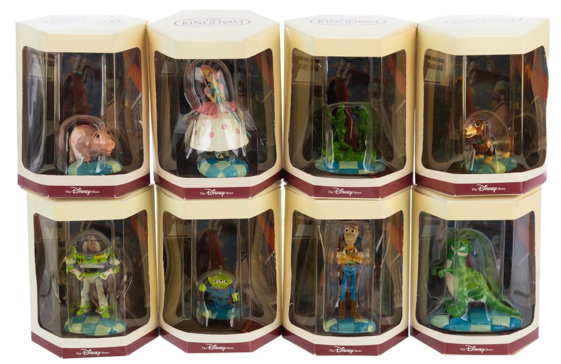 A “Toy Story?? Tiny Kingdom Figurine Collection.: (Disney Store, 1990s) A collection of eight “Toy Story” Tiny Kingdom figures in their original boxes, including Woody, Slinky Dog, Hamm, Buzz, Rex, an Alien, Bo Peep and Green Army Men. Measur