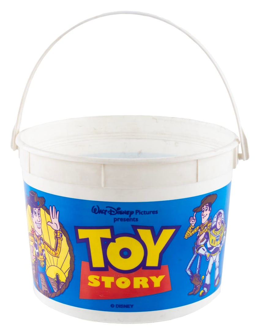 A 1995 "Toy Story" Popcorn Bucket.: (Disney, 1995) A popcorn bucket for Pixar’s first feature film “Toy Story,” from the original run at the El Capitan theater in Hollywood. Measuring 8” in diameter x 6” high, the 