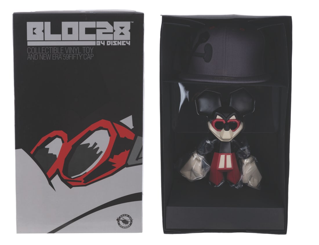 A Large Block28 Mickey Mouse Figure Set.: (Span of Sunset, 2008) A Mickey Mouse articulated vinyl figure and New Era fitted hat set, designed by James T. Quinn III. Disney's Bloc28 initiative commissioned emerging talents from the street art 