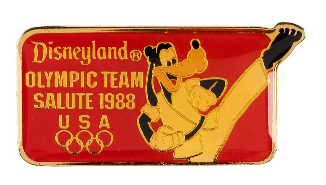 A Goofy Olympic Martial Arts Pin.: (Disneyland, 1988) A Disneyland Olympic Team Salute 1988 pin, featuring Goofy performing martial arts. Measuring 1.5 " wide, the pin is in very good condition with typical color shift from age.