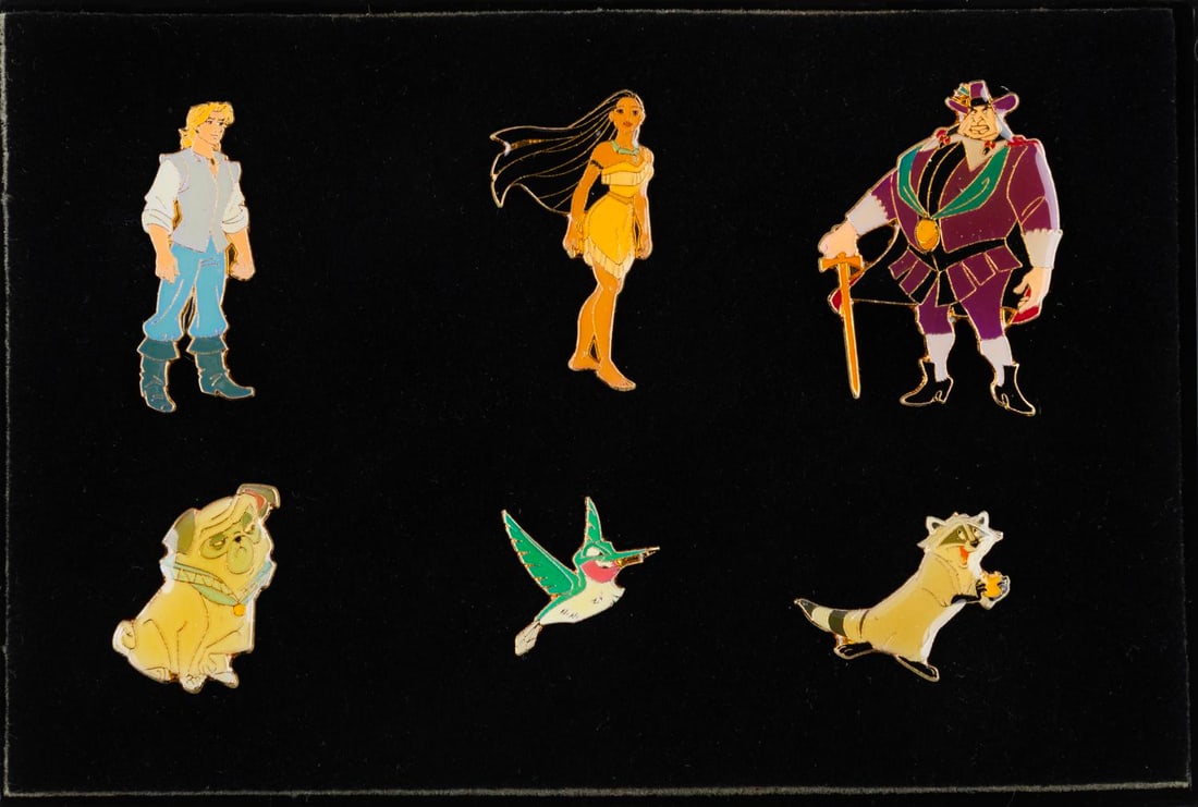 A 6-Piece "Pocahontas" Character Pin Set.: (Disney Store, 1995) A six-piece "Pocahontas" pin set featuring Pocahontas, John Smith, Meeko, Flit, Percy, and Governor Ratcliffe. Measuring approximately 1.5" x 1" each, the pins are in fine conditi