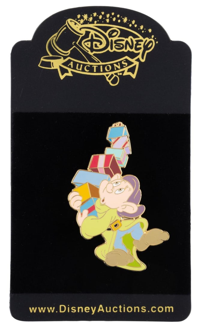 A Dopey Disney Auctions Pin.: (Disney, 2000s) A Disney Auctions pin of Dopey balancing presents, released in a limited edition of 1000. The pin is in fine condition on the original card.
