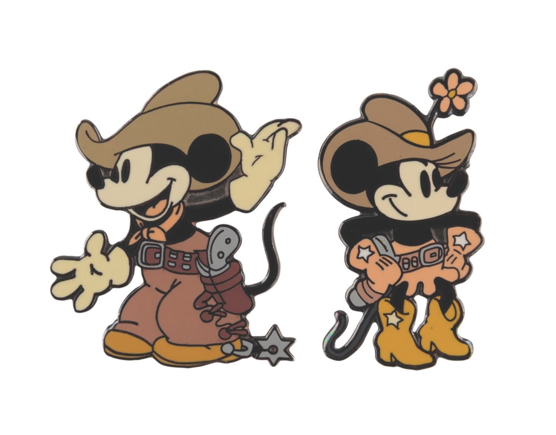 A Pair of "Two-Gun Mickey" Pins.: (Disney, 2000) A pair of "Two-Gun Mickey" pins of Mickey and Minnie Mouse, released in a limited edition of 2500. The pins are in very good condition with light scratches and wear.