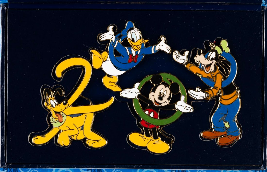 A Walt Disney World “Hand in Hand 2000?? Pin Set.: (Walt Disney World, 2000) A box set of four pins commemorating the "Celebrate the Future Hand in Hand" Millennium event, featuring Mickey Mouse, Pluto, Donald Duck, and Goofy. Ranging in size from 1.2