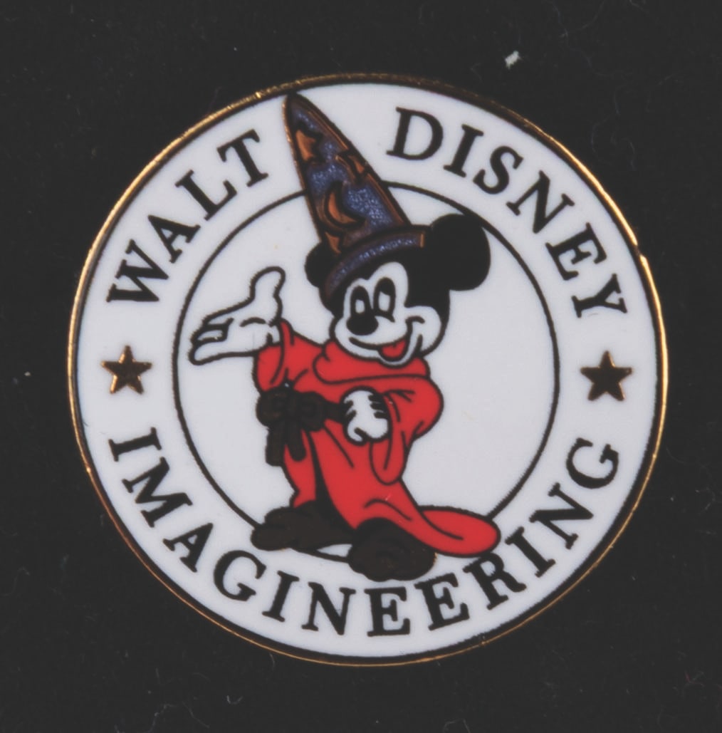A Walt Disney Imagineering Sorcerer Mickey Pin.: (WDI, 2000) A Sorcerer Mickey pin released exclusively for Cast Members and sold at Mickey’s of Glendale on the Imagineering Campus. Measuring just under 1” in diameter, the pin is in fine con