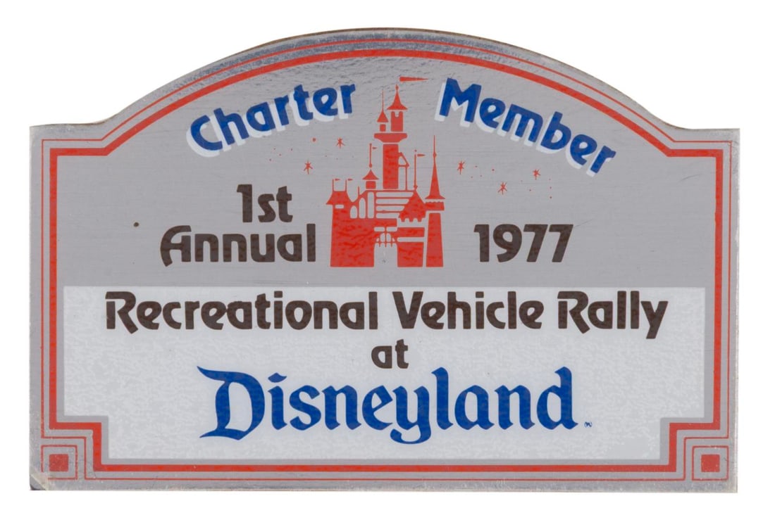 A Charter Member Disneyland RV Rally Emblem.: (Disneyland, 1977) A plaque-style decal from the Disneyland Recreational Vehicle Rally. Featuring printed text on a reflective background that reads "1st Annual 1977 Recreational Rally Disneyland,"