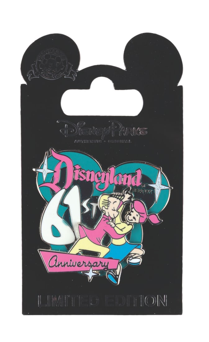 A Disneyland 61st Anniversary Pin.: (Disneyland, 2016) A Disneyland 61st anniversary pin featuring a Date Nite-inspired design, exclusively available to Cast Members. The pin is in fine condition on its original card.